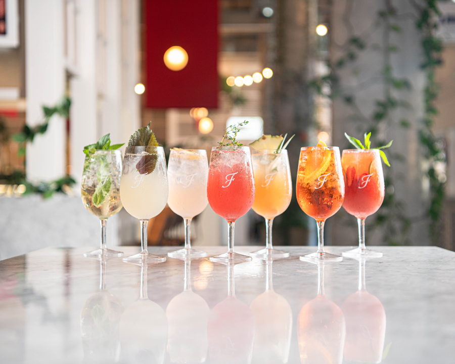 Colourful spritzes lined up on the Fratelli Fresh marble bar