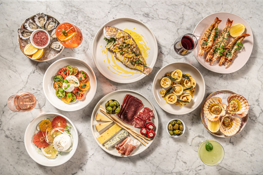 Overhead Italian seafood and antipasti spread on marble