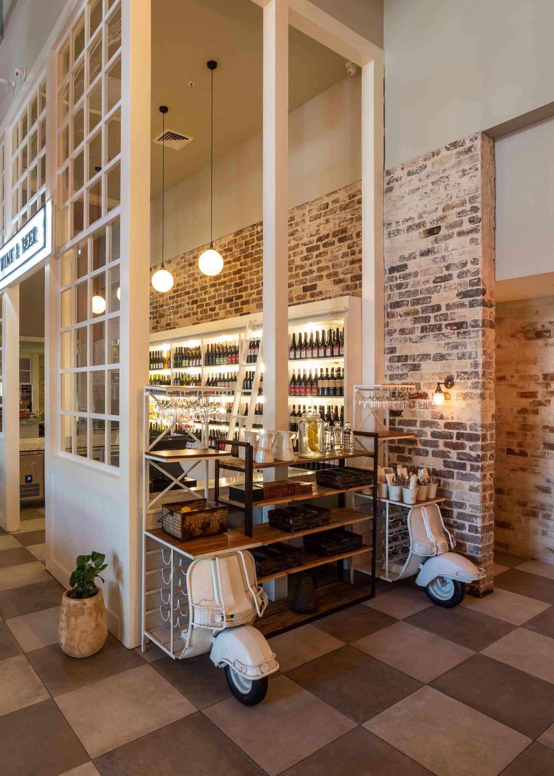 Fratelli Fresh interior with wine wall and warm brick detail